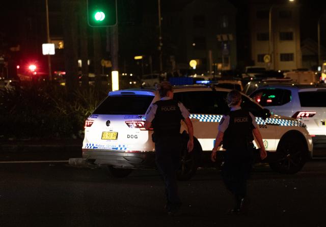 (251214) -- SYDNEY, Dec. 14, 2025 (Xinhua) -- Police officers work near the shooting site at Bondi Beach in Sydney, Australia, on Dec. 14, 2025. At least 12 people have died after a shooting at Sydney's Bondi Beach on Sunday night, said New South Wales Premier Chris Minns.
   One of the offenders was among the dead and another one is in custody, the Australian Broadcasting Corporation (ABC) cited Minns as saying. (Xinhua/Ma Ping)