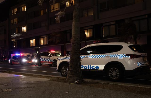 (251214) -- SYDNEY, Dec. 14, 2025 (Xinhua) -- Police vehicles are seen near the shooting site at Bondi Beach in Sydney, Australia, on Dec. 14, 2025. At least 12 people have died after a shooting at Sydney's Bondi Beach on Sunday night, said New South Wales Premier Chris Minns.
   One of the offenders was among the dead and another one is in custody, the Australian Broadcasting Corporation (ABC) cited Minns as saying. (Xinhua/Ma Ping)