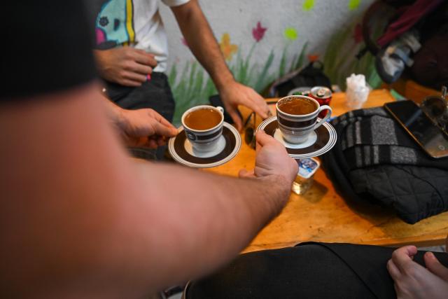 (251214) -- ISTANBUL, Dec. 14, 2025 (Xinhua) -- A staff member serves brewed coffee to customers at the Turkish cafe Mandabatmaz in Istanbul, Türkiye, Nov. 22, 2025.
  Mandabatmaz, a Turkish cafe, is located in a small alley beside Istiklal Avenue in Istanbul.
  The owner, Can Ozmen, took over this small coffee shop with a history of nearly sixty years from his parents. To carry on the tradition, he still insists on brewing coffee with copper pots. Ozmen introduced that Turkish coffee should be consumed with coffee grounds, which makes Turkish coffee unique. "Unlike other coffees, which are filtered, Turkish coffee is enjoyed in its entirety," Ozmen explained.
  Turkish coffee has a long history and was inscribed on UNESCO's Representative List of the Intangible Cultural Heritage of Humanity in 2013.
  While in China, a riverside cafe in Yunnan also wins fame among coffee lovers.
  Li Jinhe, 53, has operated his cafe in Mangkuan under Baoshan City in Gaoligong Mountains for 14 years.
  His "flame-brewed coffee", which made by a blowtorch to heat beneath siphon pots, has taken the Internet by storm for its originality, turning his cafe into a viral sensation.
  Tourists said that the coffee shop by the Nujiang River has broken the stereotype of urban coffee, and coffee should be a daily drink integrated into life.
  "I grew up here, and love Gaoligong Mountains," said Li. The Gaoligong Mountains, where fertile soil, ideal temperatures and abundant sunlight situate it within the global coffee-growing belt, boast small-bean coffee. "It is my unwavering commitment to promote local small-bean coffee," added Li.
  Although made by different ways, both Turkish and Chinese coffee tell the story of people's pursuit of life with warmth and aroma. (Xinhua/Liu Lei)