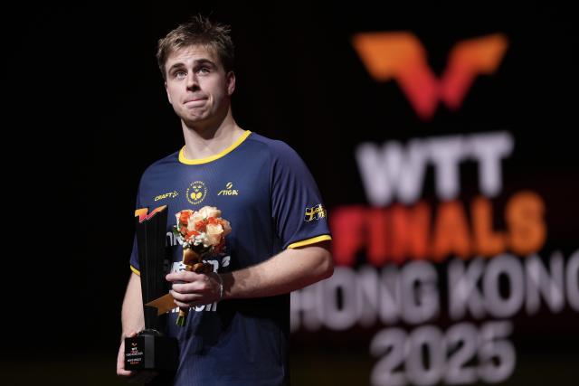 (251214) -- HONG KONG, Dec. 14, 2025 (Xinhua) -- Truls Moregard of Sweden reacts during the awarding ceremony at the WTT Finals Hong Kong 2025 in Hong Kong, south China, Dec. 14, 2025. (Xinhua/Lui Siu Wai)