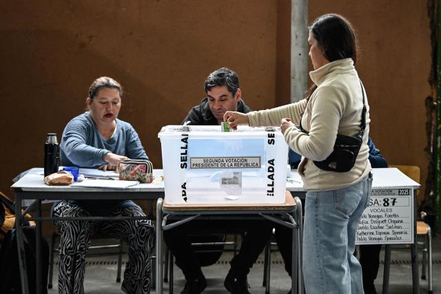 (251214) -- SANTIAGO, Dec. 14, 2025 (Xinhua) -- A local resident casts her vote at a polling station in Santiago, Chile, Dec. 14, 2025. Voting in the Chilean presidential runoff election opened on Sunday, with leftist candidate Jeannette Jara and Republican contender Jose Antonio Kast competing in the runoff. (Photo by Jorge Villegas/Xinhua)