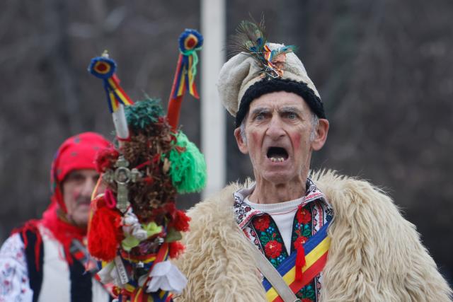 (251215) -- BUCHAREST, Dec. 15, 2025 (Xinhua) -- A member of a traditional dance group performs during the "White Flowers" festival of traditions and customs at the Village Museum in Bucharest, Romania, on Dec. 14, 2025. (Photo by Cristian Cristel/Xinhua)