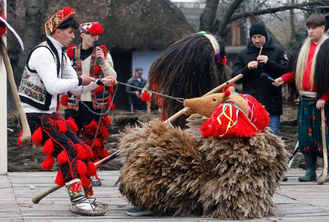 (251215) -- BUCHAREST, Dec. 15, 2025 (Xinhua) -- Members of a traditional dance group perform during the "White Flowers" festival of traditions and customs at the Village Museum in Bucharest, Romania, on Dec. 14, 2025. (Photo by Cristian Cristel/Xinhua)