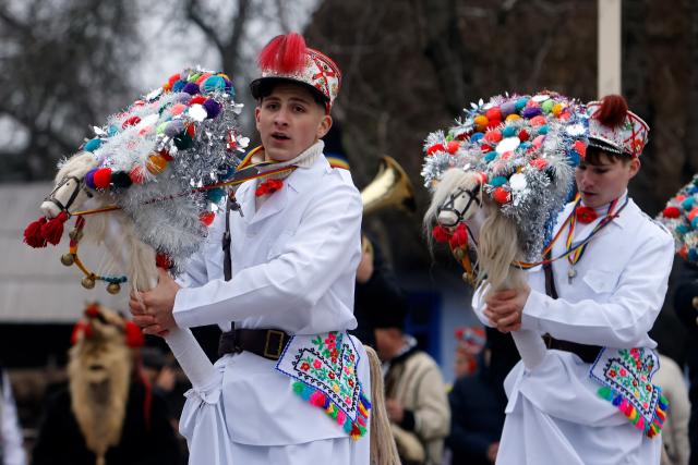 (251215) -- BUCHAREST, Dec. 15, 2025 (Xinhua) -- Members of a traditional dance group perform during the "White Flowers" festival of traditions and customs at the Village Museum in Bucharest, Romania, on Dec. 14, 2025. (Photo by Cristian Cristel/Xinhua)