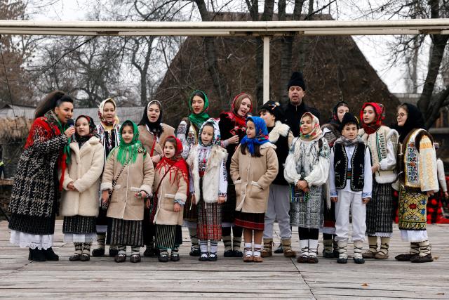 (251215) -- BUCHAREST, Dec. 15, 2025 (Xinhua) -- Members of a traditional choir group perform during the "White Flowers" festival of traditions and customs at the Village Museum in Bucharest, Romania, on Dec. 14, 2025. (Photo by Cristian Cristel/Xinhua)