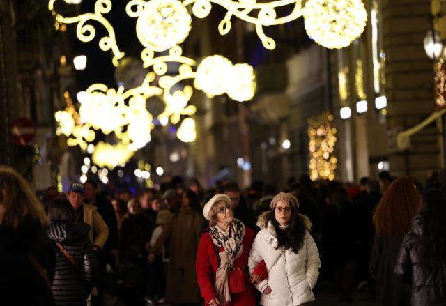 (251215) -- ROME, Dec. 15, 2025 (Xinhua) -- People walk under Christmas lights at Via dei Condotti in Rome, Italy, Dec. 14, 2025. (Xinhua/Li Jing)