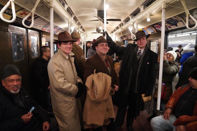 (251215) -- NEW YORK, Dec. 15, 2025 (Xinhua) -- People in vintage clothing take a ride on the Holiday Nostalgia Train in New York City, the United States, on Dec. 14, 2025.
  Holiday Nostalgia Train, vintage 1930s train cars, is running every Sunday in December to celebrate the holiday season here in New York, taking passengers to step back in time. (Xinhua/Zhang Fengguo)