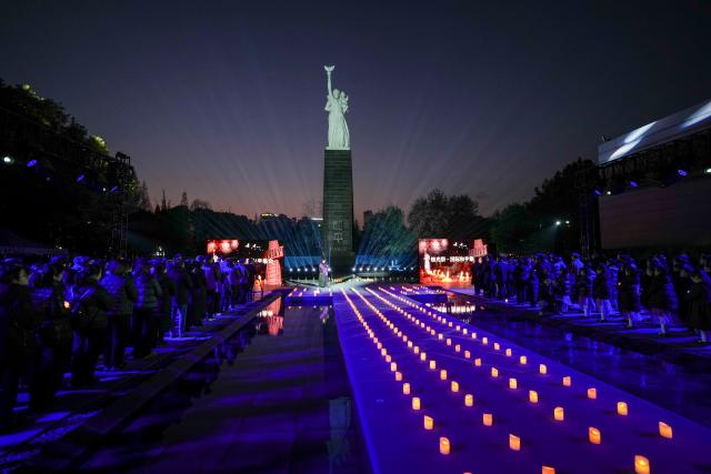 (251215) -- BEIJING, Dec. 15, 2025 (Xinhua) -- People attend a candle-light vigil at the Memorial Hall of the Victims in Nanjing Massacre by Japanese Invaders in Nanjing, capital of east China's Jiangsu Province, Dec. 13, 2025.
  A candle-light vigil was held at the memorial hall on Dec. 13, which was the 12th national memorial day for the victims of the Nanjing Massacre. (Xinhua/Li Bo)