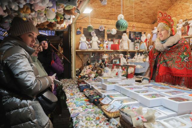 (251215) -- BEIJING, Dec. 15, 2025 (Xinhua) -- Tourists buy souvenirs at a Christmas market in St. Petersburg, Russia, Dec. 13, 2025.
  A Christmas market opened here on Dec. 13 for the upcoming Christmas and New Year holidays. (Photo by Irina Motina/Xinhua)