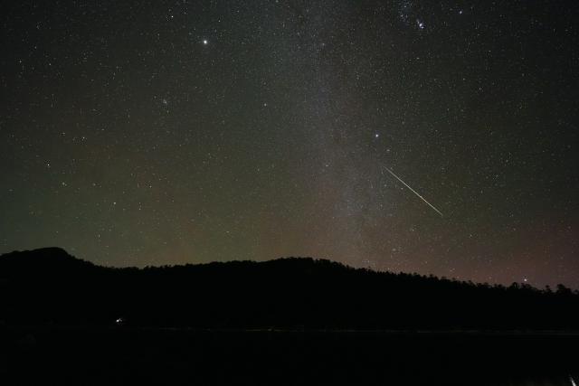 (251215) -- KANGDING, Dec. 15, 2025 (Xinhua) -- This photo taken on Dec. 14, 2025 shows the Geminid meteor shower in the sky over Niujiaohai Lake in Ganluo County, southwest China's Sichuan Province.
  The Geminid meteor shower, one of the most spectacular meteor showers of the year, reached its peak on Dec. 14. (Xinhua/Jiang Hongjing)
