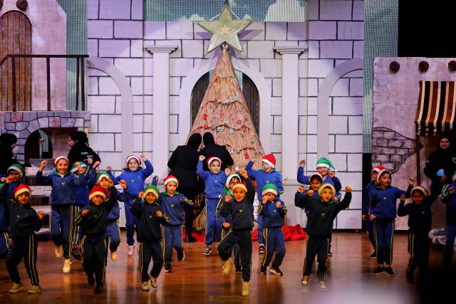 (251215) -- BEIRUT, Dec. 15, 2025 (Xinhua) -- Children celebrate in front of a Christmas tree made from natural soap and aromatic herbs in Beirut, Lebanon, Dec. 15, 2025. This Christmas tree weighs more than 2,000 kilograms and stands 3.5 meters tall. (Xinhua/Bilal Jawich)