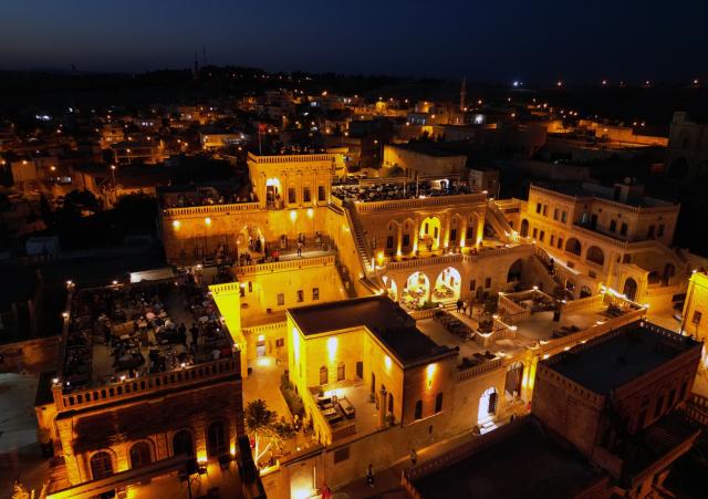 (251215) -- MIDYAT, Dec. 15, 2025 (Xinhua) -- An aerial drone photo taken on Dec. 14, 2025 shows a night view of the historic Anitli neighborhood in Midyat, Mardin province, Türkiye. Anitli has been named one of the "Best Tourism Villages 2025" by the United Nations World Tourism Organization (UNWTO), a designation expected to further boost the area's growing tourism momentum. It has preserved its natural charm and is home to historic landmarks that captivate visitors. (Mustafa Kaya/Handout via Xinhua)