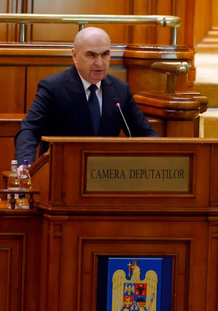 (251215) -- BUCHAREST, Dec. 15, 2025 (Xinhua) -- Romania's Prime Minister Ilie Bolojan speaks during a no-confidence motion at Parliament Palace in Bucharest, Romania, Dec. 15, 2025. Romania's parliament on Monday rejected a no-confidence motion against the government of Prime Minister Ilie Bolojan after it failed to secure the required majority in a joint session. (Photo by Cristian Cristel/Xinhua)
