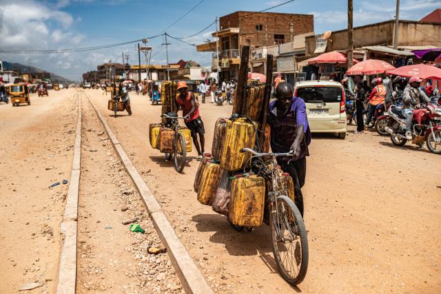 (251215) -- UVIRA, Dec. 15, 2025 (Xinhua) -- People transport goods by bike in Uvira, a city in South Kivu Province in the eastern Democratic Republic of the Congo (DRC), on Dec. 15, 2025. In Uvira, a strategic city in eastern DRC, streets are being swept, shops are cautiously reopening, and residents are stepping back into public spaces as daily life begins to move again. (Photo by Zanem Nety Zaidi/Xinhua)