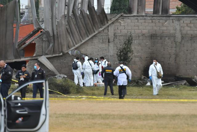 (251215) -- TOLUCA, Dec. 15, 2025 (Xinhua) -- Personnel from the State of Mexico prosecutor's office work at the aircraft crash site in Toluca, the State of Mexico, central Mexico, Dec. 15, 2025. At least six people were killed Monday after a small aircraft crashed in the municipality of San Mateo Atenco in Mexico's central State of Mexico, local authorities said. (Photo by Arturo Hernandez/Xinhua)