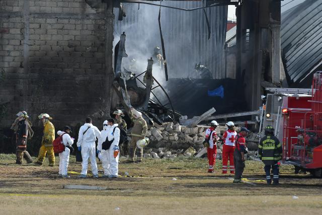 (251215) -- TOLUCA, Dec. 15, 2025 (Xinhua) -- Emergency crews work at the aircraft crash site in Toluca, the State of Mexico, central Mexico, Dec. 15, 2025. At least six people were killed Monday after a small aircraft crashed in the municipality of San Mateo Atenco in Mexico's central State of Mexico, local authorities said. (Photo by Arturo Hernandez/Xinhua)