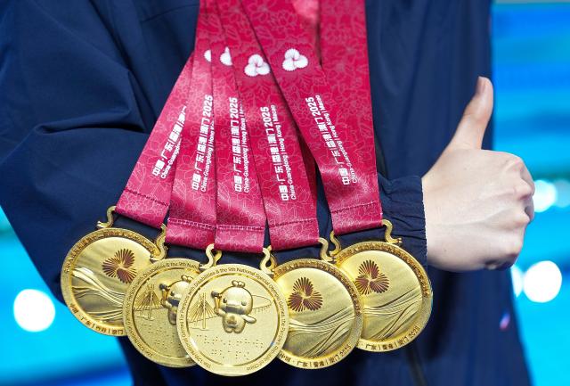 (251216) -- BEIJING, Dec. 16, 2025 (Xinhua) -- Sun Yuliang of Inner Mongolia shows the medals he won in swimming events at China's 12th National Games for Persons with Disabilities and the 9th National Special Olympic Games in Jiangmen, south China's Guangdong Province, Dec. 14, 2025. (Xinhua/Wu Zhizun)