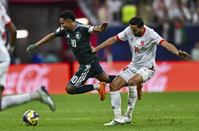 (251216) -- AL KHOR, Dec. 16, 2025 (Xinhua) -- Salem Aldawsari (L) of Saudi Arabia vies with Rajaei Ayed of Jordan during the FIFA Arab Cup 2025 Semi-final match between Saudi Arabia and Jordan at Al Bayt Stadium in Al Khor, Qatar, on Dec. 15, 2025. (Photo by Nikku/Xinhua)