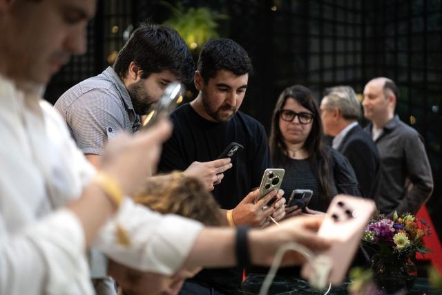 (251216) -- BUENOS AIRES, Dec. 16, 2025 (Xinhua) -- People visit the Huawei product launch event in Buenos Aires, Argentina, Dec. 15, 2025. Chinese tech giant Huawei launched a series of new cellphones and equipment on Monday in Buenos Aires, marking its return to the Argentine smartphone market after six years. (Photo by Martin Zabala/Xinhua)
