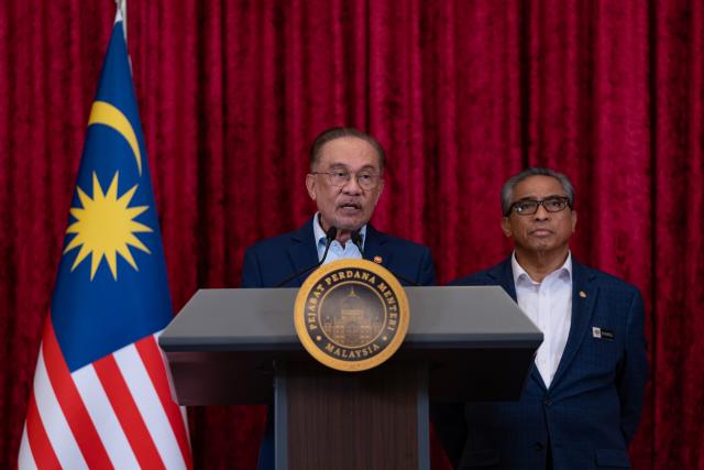 (251216) -- PUTRAJAYA, Dec. 16, 2025 (Xinhua) -- Malaysian Prime Minister Anwar Ibrahim (front) attends a press conference in Putrajaya, Malaysia, Dec. 16, 2025. Anwar unveiled new ministerial appointments on Tuesday as part of a cabinet reshuffle. (Prime Minister's Office of Malaysia/Handout via Xinhua)