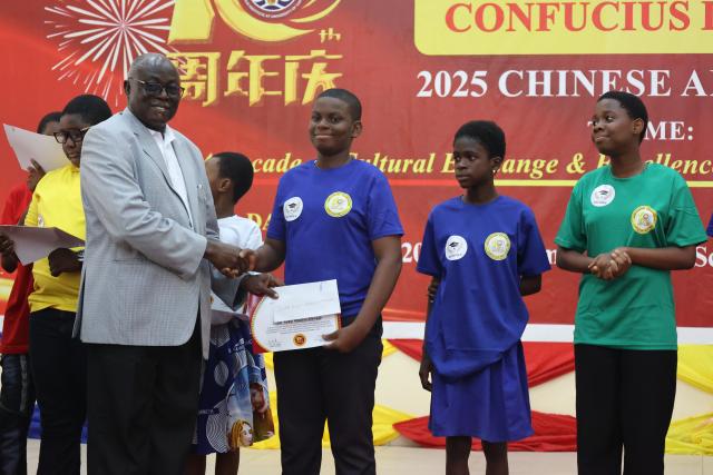 (251216) -- CAPE COAST, Dec. 16, 2025 (Xinhua) -- A student (3rd R) receives an award during a celebration marking the 10th anniversary of the Confucius Institute at the University of Cape Coast in Cape Coast, capital of Ghana's Central Region, Dec. 15, 2025. The Confucius Institute at the University of Cape Coast on Monday marked 10 years of Chinese language and culture education in the historical town of Cape Coast, capital of Ghana's Central Region. (Photo by Seth/Xinhua)
