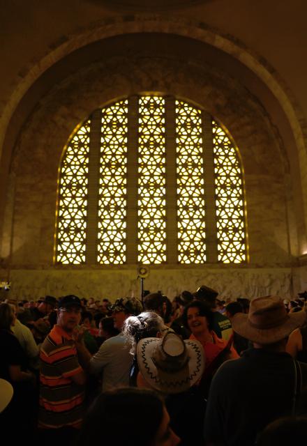 (251216) -- PRETORIA, Dec. 16, 2025 (Xinhua) -- A beam of sunlight shines on a woman before noon as people gather to celebrate the Day of Reconciliation at the Voortrekker Monument in Pretoria, South Africa, on Dec. 16, 2025. December 16 was called the Day of the Vow in South Africa. It was renamed the Day of Reconciliation in 1994 after the end of apartheid, with the intention of fostering reconciliation and national unity. (Xinhua/Chen Wei)