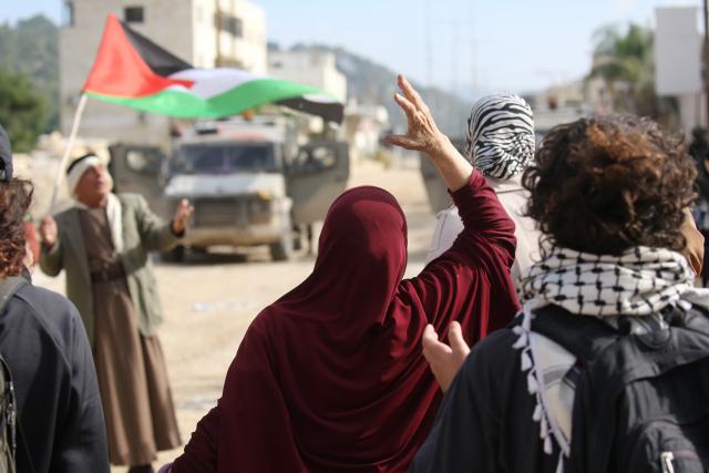 (251216) -- TULKARM, Dec. 16, 2025 (Xinhua) -- Palestinians protest as the Israeli army blocks the street at the main entrance of Nur Shams camp, east of Tulkarm city in the West Bank, on Dec. 15, 2025. (Photo by Nidal Eshtayeh/Xinhua)