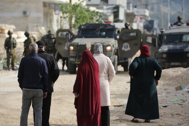 (251216) -- TULKARM, Dec. 16, 2025 (Xinhua) -- Palestinians protest as the Israeli army blocks the street at the main entrance of Nur Shams camp, east of Tulkarm city in the West Bank, on Dec. 15, 2025. (Photo by Nidal Eshtayeh/Xinhua)