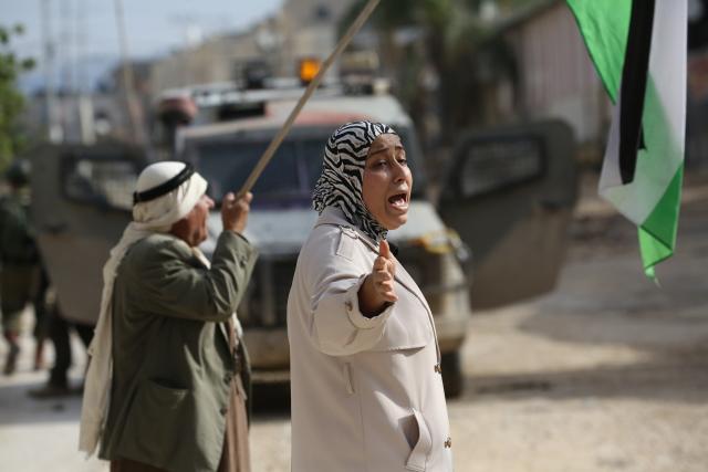 (251216) -- TULKARM, Dec. 16, 2025 (Xinhua) -- Palestinians protest as the Israeli army blocks the street at the main entrance of Nur Shams camp, east of Tulkarm city in the West Bank, on Dec. 15, 2025. (Photo by Nidal Eshtayeh/Xinhua)