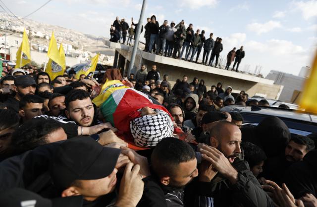 (251217) -- BETHLEHEM, Dec. 17, 2025 (Xinhua) -- Mourners carry the body of Palestinian boy Ammar Ta'amra, who was shot dead by Israeli army, during his funeral in the town of Tuqu', southeast of Bethlehem in the West Bank, on Dec. 16, 2025. The 16-year-old Palestinian, Ammar Ta'amra, was shot dead, by the Israeli army during a military raid on Tuqu' on Monday, the Palestinian health ministry said. (Photo by Mamoun Wazwaz/Xinhua)