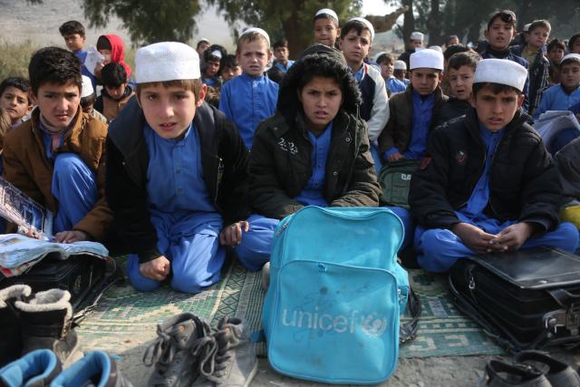 (251217) -- NANGARHAR, Dec. 17, 2025 (Xinhua) -- Students take a class in the open air at a makeshift roadside school without proper shelters beside a highway junction in Nangarhar province, eastern Afghanistan, Dec. 16, 2025. (Photo by Saifurahman Safi/Xinhua)