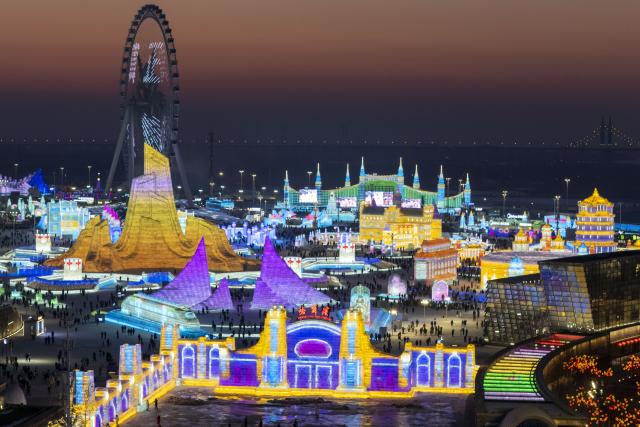 (251217) -- HARBIN, Dec. 17, 2025 (Xinhua) -- An aerial drone photo taken on Dec. 17, 2025 shows tourists visiting the Harbin Ice-Snow World in Harbin, northeast China's Heilongjiang Province. The Harbin Ice-Snow World, world's largest ice and snow theme park, officially opened for the season on Wednesday, unveiling its most spectacular edition yet, featuring landmark attractions, thoughtful services and magnificent ice sculptures across a record 1.2 million square meters of park area. (Xinhua/Zhang Tao)