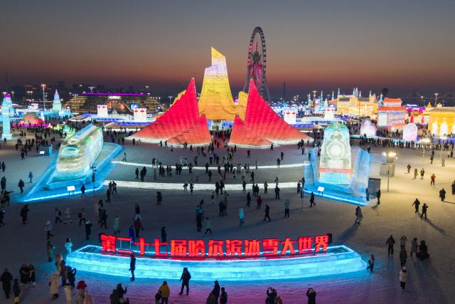 (251217) -- HARBIN, Dec. 17, 2025 (Xinhua) -- An aerial drone photo taken on Dec. 17, 2025 shows tourists visiting the Harbin Ice-Snow World in Harbin, northeast China's Heilongjiang Province. The Harbin Ice-Snow World, world's largest ice and snow theme park, officially opened for the season on Wednesday, unveiling its most spectacular edition yet, featuring landmark attractions, thoughtful services and magnificent ice sculptures across a record 1.2 million square meters of park area. (Xinhua/Xie Jianfei)