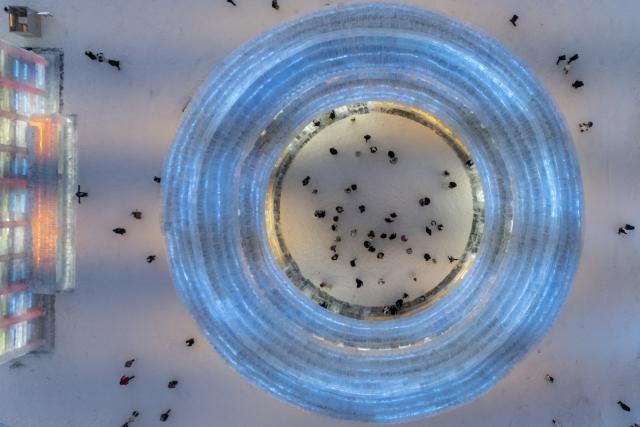 (251217) -- HARBIN, Dec. 17, 2025 (Xinhua) -- An aerial drone photo taken on Dec. 17, 2025 shows tourists visiting the Harbin Ice-Snow World in Harbin, northeast China's Heilongjiang Province. The Harbin Ice-Snow World, world's largest ice and snow theme park, officially opened for the season on Wednesday, unveiling its most spectacular edition yet, featuring landmark attractions, thoughtful services and magnificent ice sculptures across a record 1.2 million square meters of park area. (Xinhua/Zhang Tao)
