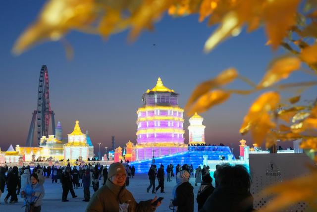(251217) -- HARBIN, Dec. 17, 2025 (Xinhua) -- Tourists visit the Harbin Ice-Snow World in Harbin, northeast China's Heilongjiang Province, Dec. 17, 2025. The Harbin Ice-Snow World, world's largest ice and snow theme park, officially opened for the season on Wednesday, unveiling its most spectacular edition yet, featuring landmark attractions, thoughtful services and magnificent ice sculptures across a record 1.2 million square meters of park area. (Xinhua/Wang Jianwei)