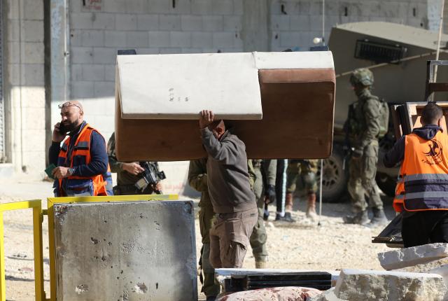 (251217) -- TULKARM, Dec. 17, 2025 (Xinhua) -- A Palestinian carries his belonging in the Nur Shams refugee camp, east of Tulkarm in the West Bank, on Dec. 17, 2025. Previously the Israeli army announced the demolition of 25 homes in the Nur Shams refugee camp and allowed the homeowners to enter their homes and move their furniture and belongings on Wednesday morning. (Photo by Nidal Eshtayeh/Xinhua)