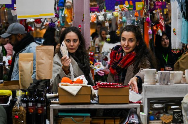 (251217) -- ISTANBUL, Dec. 17, 2025 (Xinhua) -- Customers shop at the New Year Shopping Festival at the Clock Tower Square of Galataport in Istanbul, Türkiye, Dec. 17, 2025. As the New Year approaches, tents have been set up at Clock Tower Square in Galataport for a New Year Shopping Festival, offering a variety of festive-themed goods. (Xinhua/Liu Lei)
