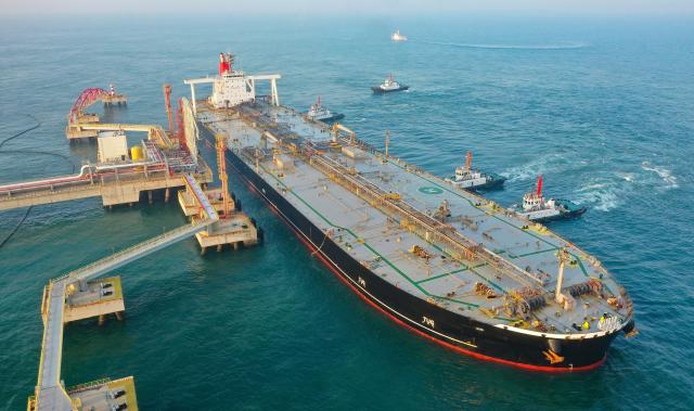 (251218) -- HAIKOU, Dec. 18, 2025 (Xinhua) -- An aerial drone photo shows a foreign vessel carrying petrochemical raw materials berthing at Yangpu Port in Danzhou, south China's Hainan Province, Dec. 18, 2025. China on Thursday launched island-wide special customs operations in the Hainan Free Trade Port (FTP). (Xinhua/Guo Cheng)