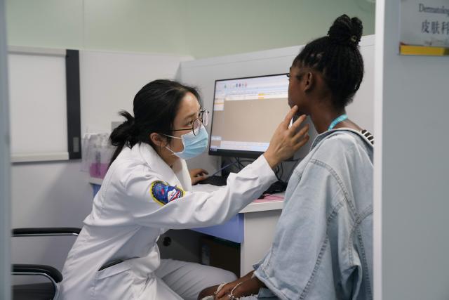 (251218) -- BEIJING, Dec. 18, 2025 (Xinhua) -- A dermatologist from the Chinese Navy hospital ship "Silk Road Ark" provides medical treatment for a patient in Montego Bay, Jamaica, Dec. 7, 2025. (Photo by He Yuqian/Xinhua)