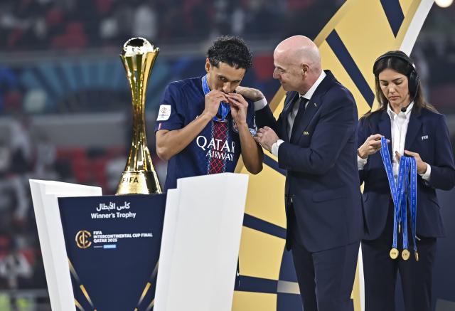 (251218) -- AL RAYYAN, Dec. 18, 2025 (Xinhua) -- FIFA President, Gianni Infantino (C) presents a medal to Marquinhos (L) of Paris Saint-Germain (PSG)  during the podium ceremony after the FIFA Intercontinental Cup 2025 final match between France's Paris Saint-Germain (PSG) and Brazil's CR Flamengo in Al Rayyan, Qatar, on Dec. 17, 2025. (Photo by Nikku/Xinhua)