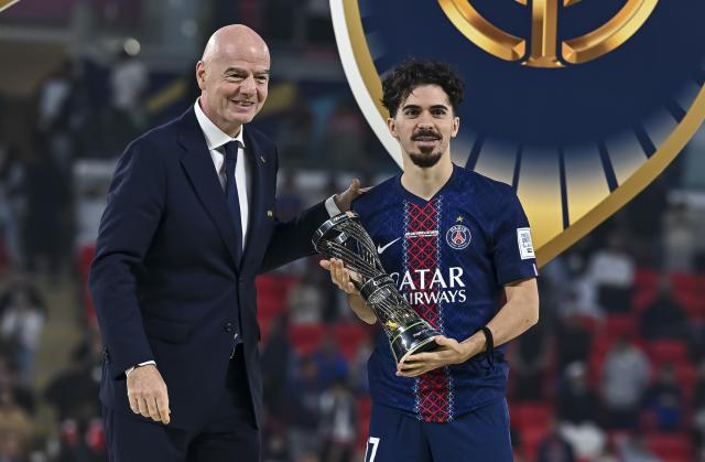 (251218) -- AL RAYYAN, Dec. 18, 2025 (Xinhua) -- FIFA President, Gianni Infantino (L) presents the Player of The Tournament award to Vitinha of Paris Saint-Germain (PSG) during the podium ceremony after the FIFA Intercontinental Cup 2025 final match between France's Paris Saint-Germain (PSG) and Brazil's CR Flamengo in Al Rayyan, Qatar, on Dec. 17, 2025. (Photo by Nikku/Xinhua)