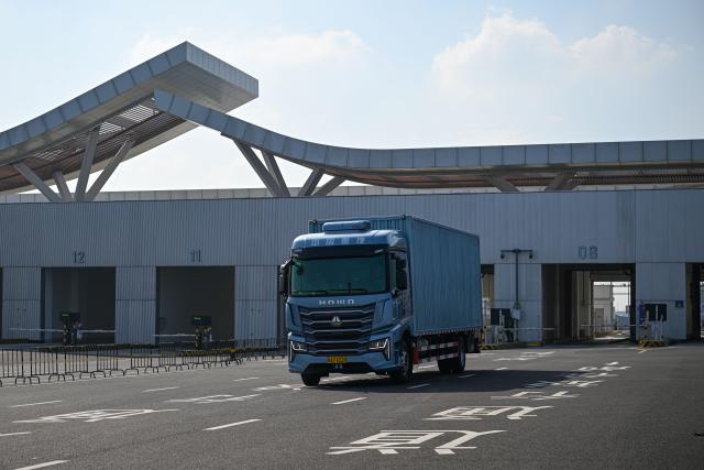(251218) -- HAIKOU, Dec. 18, 2025 (Xinhua) -- A truck carrying the first batch of goods that completed customs clearance is pictured at a centralized inspection area in Xinhai Port and Nangang Port, two "second line" customs ports, in Haikou, south China's Hainan Province, Dec. 18, 2025. China on Thursday launched island-wide special customs operations in the Hainan Free Trade Port (FTP).
  The "first line" refers to Hainan's connection with overseas markets. Meanwhile, the "second line" refers to the customs boundary between Hainan and the mainland. (Xinhua/Pu Xiaoxu)