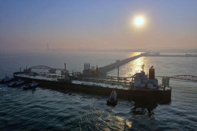 (251218) -- HAIKOU, Dec. 18, 2025 (Xinhua) -- A drone photo shows a vessel carrying 179,000 tonnes of petrochemical raw materials berthing at Yangpu Port in Danzhou, south China's Hainan Province, Dec. 18, 2025. China on Thursday launched island-wide special customs operations in the Hainan Free Trade Port (FTP).
   A vessel carrying petrochemical raw materials arrived at Yangpu Port in the morning, marking the first batch of zero-tariff petrochemical raw materials to undergo special customs clearance there after the launch of the special customs operations. The goods amounted to 179,000 tonnes, with the total value of nearly 400 million yuan (about 56.8 million U.S. dollars). (Xinhua/Guo Cheng)
