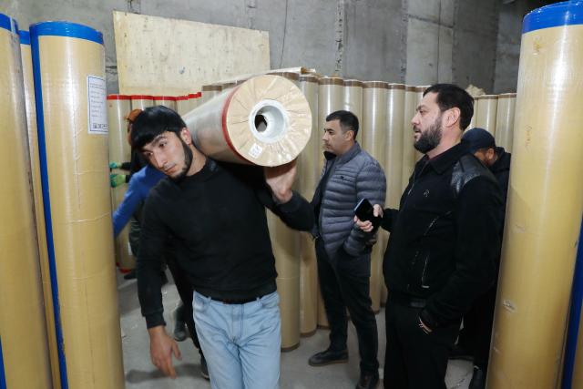 (251218) -- GUANGYUAN, Dec. 18, 2025 (Xinhua) -- A worker of a building supplies store transfers roll flooring materials from Guangyuan of southwest China's Sichuan Province, in Tashkent, Uzbekistan, Dec. 12, 2025. The home furnishing industry of Guangyuan stands out for its high quality, and its roll flooring products sell well across China and overseas.  
  In Tashkent, the capital of Uzbekistan, a building supplies store that sells flooring products from Guangyuan is doing brisk business. Jamshid Tashpulatov, the owner of the store, hopes to cooperate with more Chinese companies as the business keeps growing.
  Historically a key stop connecting China with other countries, Guangyuan is now emerging as a new landmark for western China's opening up. (Photo by Zafar Khalilov/Xinhua)
