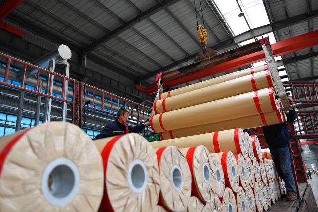(251218) -- GUANGYUAN, Dec. 18, 2025 (Xinhua) -- A worker works at a roll flooring manufacturing workshop in Guangyuan, southwest China's Sichuan Province, Dec. 12, 2025. The home furnishing industry of Guangyuan stands out for its high quality, and its roll flooring products sell well across China and overseas.  
  In Tashkent, the capital of Uzbekistan, a building supplies store that sells flooring products from Guangyuan is doing brisk business. Jamshid Tashpulatov, the owner of the store, hopes to cooperate with more Chinese companies as the business keeps growing.
  Historically a key stop connecting China with other countries, Guangyuan is now emerging as a new landmark for western China's opening up. (Xinhua/Chen Zhenhai)