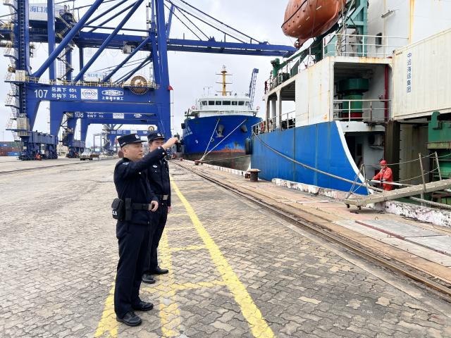 (251218) -- HAIKOU, Dec. 18, 2025 (Xinhua) -- Border inspection officers patrol at a port in Xiuying of Haikou, south China's Hainan Province, Dec. 18, 2025. China on Thursday launched island-wide special customs operations in the Hainan Free Trade Port (FTP). (Photo by Yang Jiyong/Xinhua)