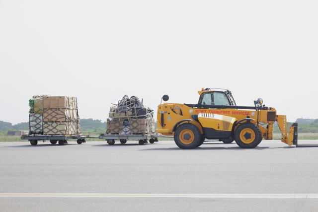 (251218) -- ACCRA, Dec. 18, 2025 (Xinhua) -- Photo taken on Dec. 17, 2025 shows a vehicle transporting part of supplies to aid Jamaica's post-hurricane reconstruction at Kotoka International Airport in Accra, Ghana. TO GO WITH "Ghanaian president vows to support Jamaica's post-hurricane construction" (Str/Xinhua)