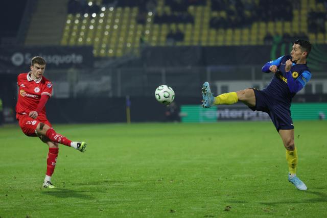 (251219) -- CELJE, Dec. 19, 2025 (Xinhua) -- Sean Gannon (L) of Shelbourne FC shoots during the UEFA Conference League match between NK Celje and Shelbourne FC in Celje, Slovenia, Dec. 18, 2025. (Photo by Zeljko Stevanic/Xinhua)