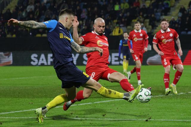(251219) -- CELJE, Dec. 19, 2025 (Xinhua) -- Franko Kovacevic (1st L) of NK Celje shoots during the UEFA Conference League match between NK Celje and Shelbourne FC in Celje, Slovenia, Dec. 18, 2025. (Photo by Zeljko Stevanic/Xinhua)