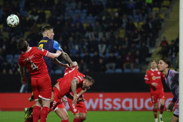 (251219) -- CELJE, Dec. 19, 2025 (Xinhua) -- Franko Kovacevic (2nd L) of NK Celje competes for a header during the UEFA Conference League match between NK Celje and Shelbourne FC in Celje, Slovenia, Dec. 18, 2025. (Photo by Zeljko Stevanic/Xinhua)